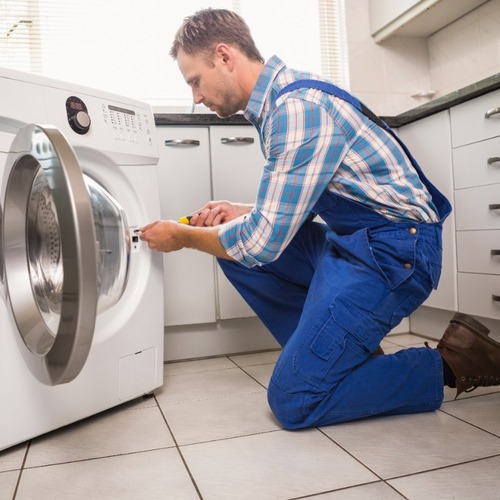 Tech Repairs a Washer