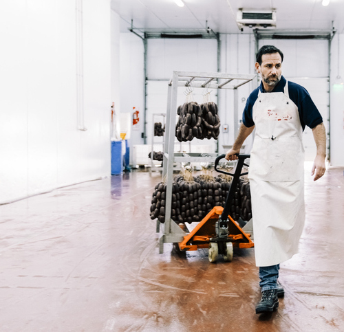 Worker Takes Food from Freezer